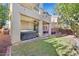 Back yard patio featuring hot tub, lush green lawn and mature trees offering privacy at 6554 Macdoogle St, Las Vegas, NV 89166