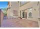 Paver and concrete back patio with mature trees features sliding door access to the home's interior at 6554 Macdoogle St, Las Vegas, NV 89166