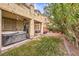 Spacious backyard with a hot tub, covered patio, and well-maintained lawn at 6554 Macdoogle St, Las Vegas, NV 89166