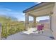 Open-air balcony features sturdy railings, two comfy chairs and gorgeous neighborhood views at 6554 Macdoogle St, Las Vegas, NV 89166