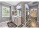 Bright bathroom featuring modern fixtures, a spacious vanity, and access to the bedroom at 6554 Macdoogle St, Las Vegas, NV 89166