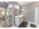 Well-lit bathroom with double sinks, a shower, and a view into the main bedroom at 6554 Macdoogle St, Las Vegas, NV 89166