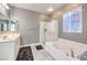 Clean bathroom with a separate shower and tub, double sinks, and ample lighting at 6554 Macdoogle St, Las Vegas, NV 89166