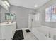 Bathroom with a vanity, soaking tub, and separate glass shower, providing a relaxing and functional space at 6554 Macdoogle St, Las Vegas, NV 89166