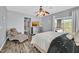Inviting bedroom with neutral tones, a comfy lounge chair, and a view to a balcony at 6554 Macdoogle St, Las Vegas, NV 89166