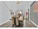 Elegant dining room with high ceilings, modern decor, and a view of the staircase at 6554 Macdoogle St, Las Vegas, NV 89166