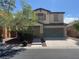 Charming two-story home featuring a well-manicured front yard and a two-car garage at 6554 Macdoogle St, Las Vegas, NV 89166
