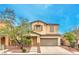 Inviting two-story home with a well-manicured front yard and attached two car garage at 6554 Macdoogle St, Las Vegas, NV 89166