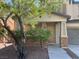Inviting front porch with stone accents and lush landscaping leading to the front door at 6554 Macdoogle St, Las Vegas, NV 89166
