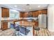 Stylish kitchen featuring stainless steel appliances, granite countertops, and a breakfast bar with seating at 6554 Macdoogle St, Las Vegas, NV 89166