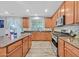 Well-equipped kitchen with stainless steel appliances, ample cabinet space, and a breakfast bar at 6554 Macdoogle St, Las Vegas, NV 89166