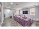 Stylish living room with modern gray walls, gray wood floors and plush purple velvet sofa at 6554 Macdoogle St, Las Vegas, NV 89166