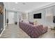 Modern living room featuring a plush purple sofa, large windows, and stylish decor at 6554 Macdoogle St, Las Vegas, NV 89166