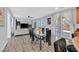 Open-concept living space with dining area, kitchen, and living room featuring modern decor and natural light at 6554 Macdoogle St, Las Vegas, NV 89166