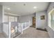 Cozy upstairs loft space with staircase, neutral carpet, and natural light, perfect for relaxation at 6554 Macdoogle St, Las Vegas, NV 89166