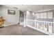 Cozy loft area with neutral paint, plush carpet, and view of the lower level at 6554 Macdoogle St, Las Vegas, NV 89166