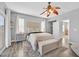 Spacious main bedroom featuring luxury vinyl floors, stylish ceiling fan, and walk-in closet at 6554 Macdoogle St, Las Vegas, NV 89166