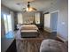 Spacious main bedroom featuring luxury vinyl floors, stylish ceiling fan, and walk-in closet at 6554 Macdoogle St, Las Vegas, NV 89166