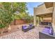 Beautiful backyard patio with stylish seating, hot tub, and lush landscaping at 6554 Macdoogle St, Las Vegas, NV 89166