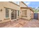This cozy patio features brick and concrete, an entry door, and a secure gate at 6554 Macdoogle St, Las Vegas, NV 89166