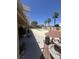 A backyard patio with a pool, palm trees, and an outdoor seating area is perfect for relaxing and entertaining guests at 6596 Secluded Ave, Las Vegas, NV 89110