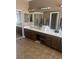 A full bathroom features tile flooring, double sinks, and ample vanity storage at 6596 Secluded Ave, Las Vegas, NV 89110