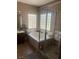 Bathroom featuring a soaking tub, glass block window, and a separate shower area at 6596 Secluded Ave, Las Vegas, NV 89110