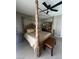 This main bedroom features a carved four-poster bed, ceiling fan and neutral decor at 6596 Secluded Ave, Las Vegas, NV 89110