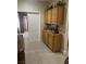 Hallway with carpet flooring, showcasing wooden cabinets and decor that enhances the home's aesthetic at 6596 Secluded Ave, Las Vegas, NV 89110