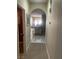 Hallway with neutral walls and carpet flooring leading to a sunlit living area, creating a cozy feel at 6596 Secluded Ave, Las Vegas, NV 89110