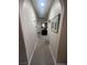 Hallway with neutral paint, carpeted floor, and decorative artwork on the wall at 6596 Secluded Ave, Las Vegas, NV 89110