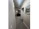 Hallway with neutral paint and carpet flooring showcasing a decorative mirror and cabinet at 6596 Secluded Ave, Las Vegas, NV 89110