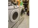 Laundry room featuring white front-loading washer and dryer with tile floors at 6596 Secluded Ave, Las Vegas, NV 89110