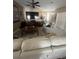 Bright living room features a ceiling fan, media center, and comfortable white furniture at 6596 Secluded Ave, Las Vegas, NV 89110