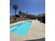 A backyard pool surrounded by lush landscaping provides a private oasis with beautiful mountain views at 6596 Secluded Ave, Las Vegas, NV 89110