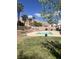 Beautiful in-ground swimming pool surrounded by lush greenery and a spacious patio area, ideal for summer fun at 6596 Secluded Ave, Las Vegas, NV 89110