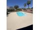 This backyard features a clean pool surrounded by decorative rock landscaping with palm trees, offering a relaxing outdoor space at 6596 Secluded Ave, Las Vegas, NV 89110