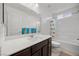 Bright bathroom featuring a vanity, tub/shower combo, and a toilet at 6626 Evander St, North Las Vegas, NV 89086