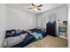 Bright bedroom with two beds, ceiling fan, and ample natural light from the window at 6626 Evander St, North Las Vegas, NV 89086