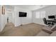 Neutral carpeted bedroom with a queen sized bed, a window and a TV at 6626 Evander St, North Las Vegas, NV 89086
