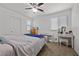 Well-lit bedroom featuring a ceiling fan, a vanity, and a keyboard against the white wall at 6626 Evander St, North Las Vegas, NV 89086