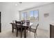 Dining area with a wood table set beneath two windows at 6626 Evander St, North Las Vegas, NV 89086