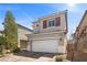 Inviting two-story home showcasing a well-maintained exterior, a two car garage and manicured landscaping at 6626 Evander St, North Las Vegas, NV 89086