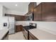 Modern kitchen with stainless steel appliances, and dark wood cabinetry at 6626 Evander St, North Las Vegas, NV 89086