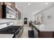 Well-lit kitchen showcasing stainless steel appliances, light quartz countertops, and dark cabinetry at 6626 Evander St, North Las Vegas, NV 89086