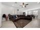 Spacious open-concept living room with ample natural light, tile flooring, and a large sectional sofa at 6626 Evander St, North Las Vegas, NV 89086