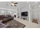 Spacious living room with tile floors, neutral walls, a ceiling fan, and a staircase at 6626 Evander St, North Las Vegas, NV 89086