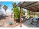 Cozy backyard with covered patio, landscaping, and gravel at 6715 Maple Mesa St, North Las Vegas, NV 89084