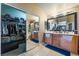 A spacious bathroom with a double sink vanity, soaking tub, and walk-in closet with mirrored doors at 6715 Maple Mesa St, North Las Vegas, NV 89084