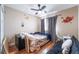 Cozy bedroom with hardwood floors, ceiling fan, and fun decorative wall stickers at 6715 Maple Mesa St, North Las Vegas, NV 89084